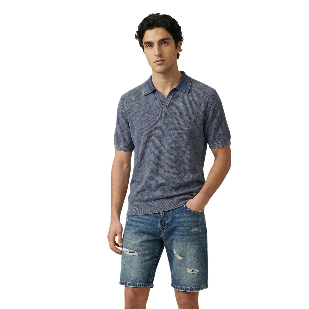 Lifestyle shot of a man in a blue polo shirt with short sleeves and a collar against a white background.