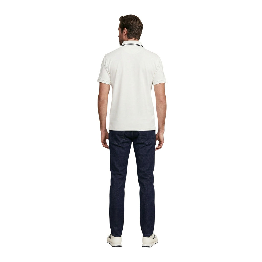 Back view of a man in a white collared polo shirt with short sleeves.