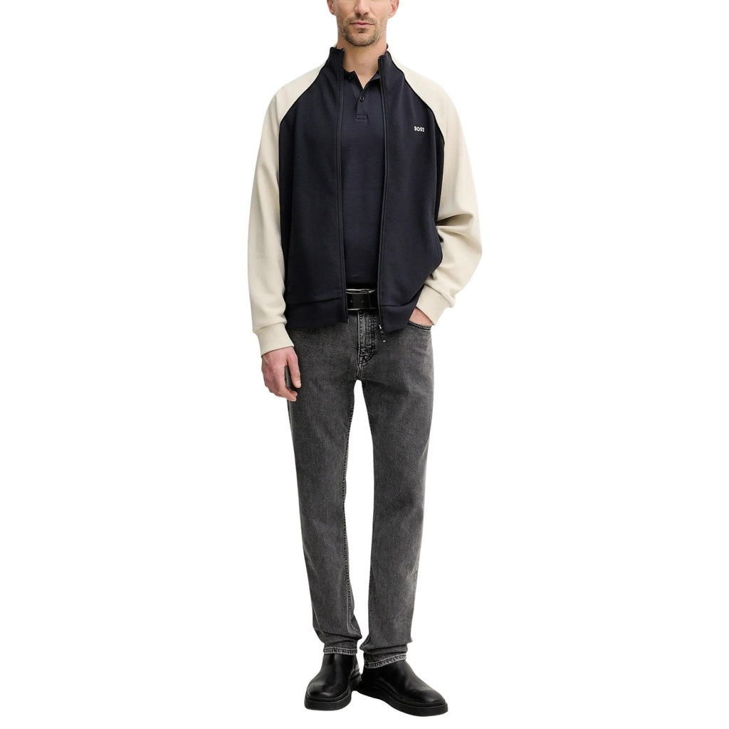Back view of gray jeans showcasing a slim fit and five pockets against a white background