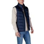 Side view of the navy puffer vest highlighting the zipper closure and padded design.