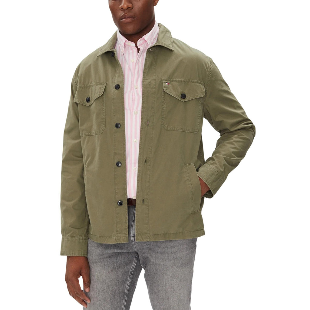 Lifestyle shot of the green blazer featuring button closure and chest pockets.