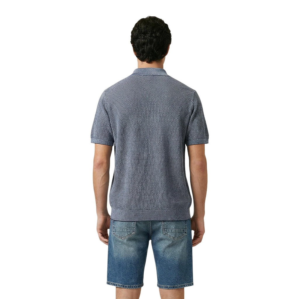 Back view of a man in a blue polo shirt with short sleeves and a collar, set against a white background.
