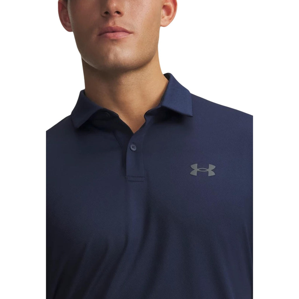 Detail close-up of the navy polo shirt's collar and logo on a white background