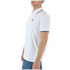 Side view of the white polo shirt showcasing the collared design and short sleeves.
