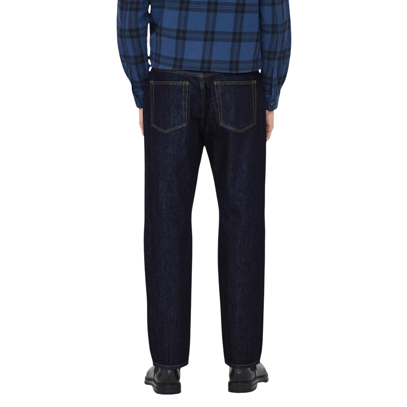 Back view of a man in a plaid shirt wearing blue jeans, highlighting the back pockets.