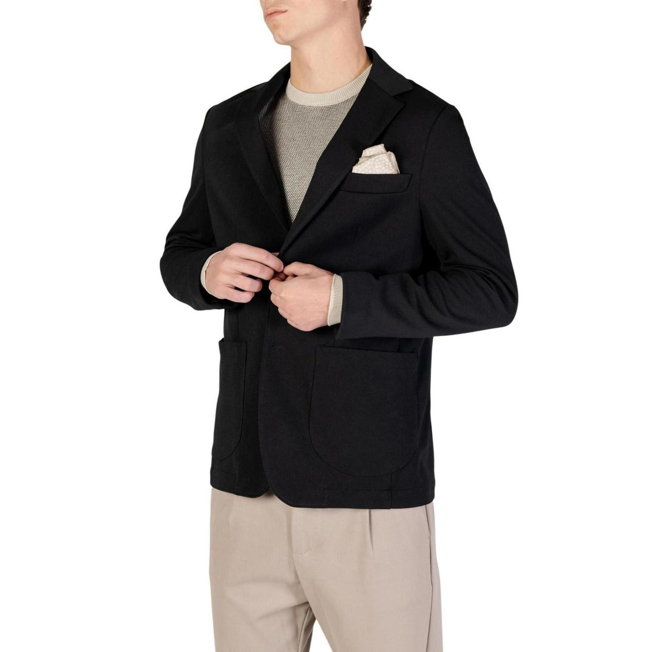 Lifestyle shot of a black blazer featuring a notched lapel and pocket square against a white background.