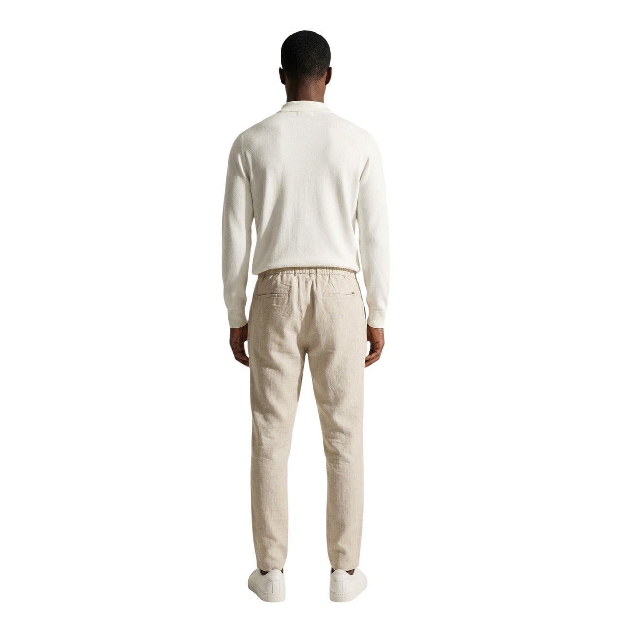 Back view of a man in a cream sweater featuring long sleeves and a casual fit.