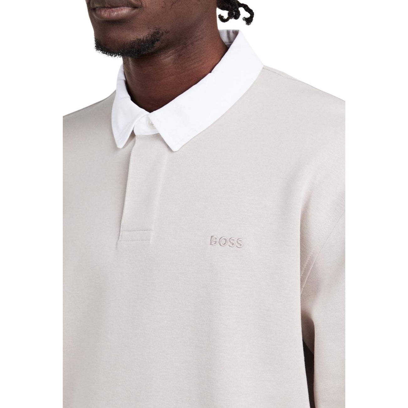 Detail close-up of the grey long-sleeve polo shirt showcasing the logo detail on a white background.