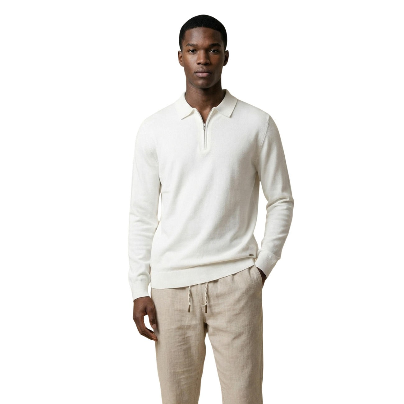 Front view of a man wearing a cream sweater with long sleeves and a classic collar.
