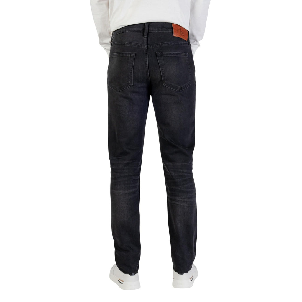 Lifestyle shot of the black slim fit jeans in a casual style on a white background