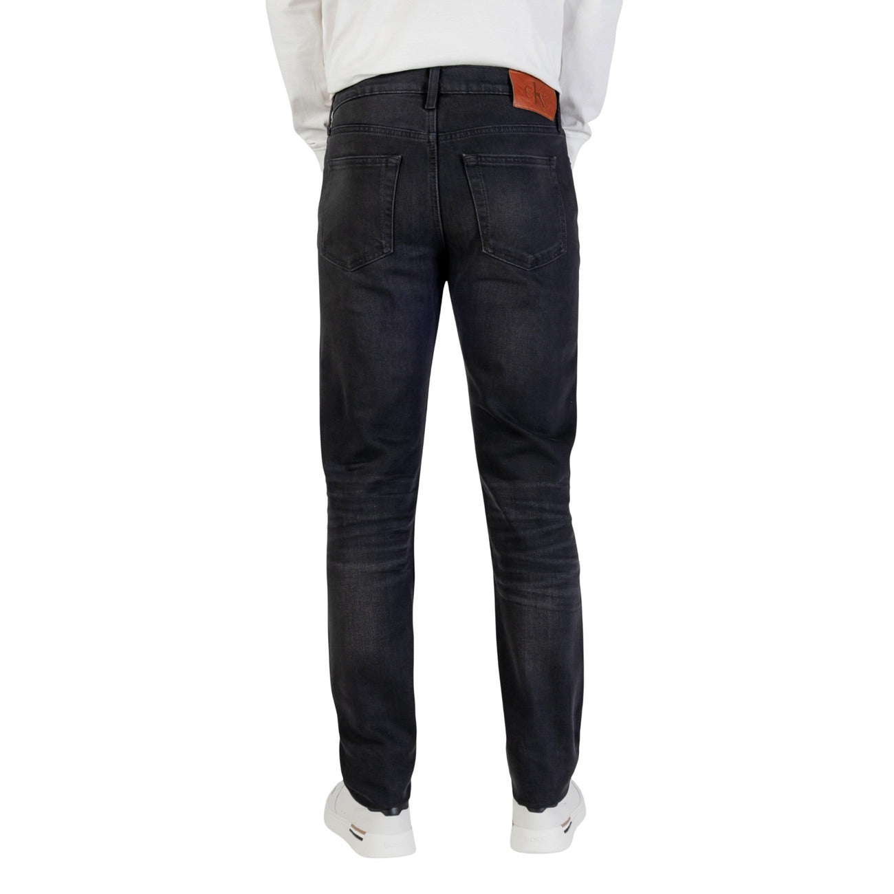 Lifestyle shot of the black slim fit jeans in a casual style on a white background