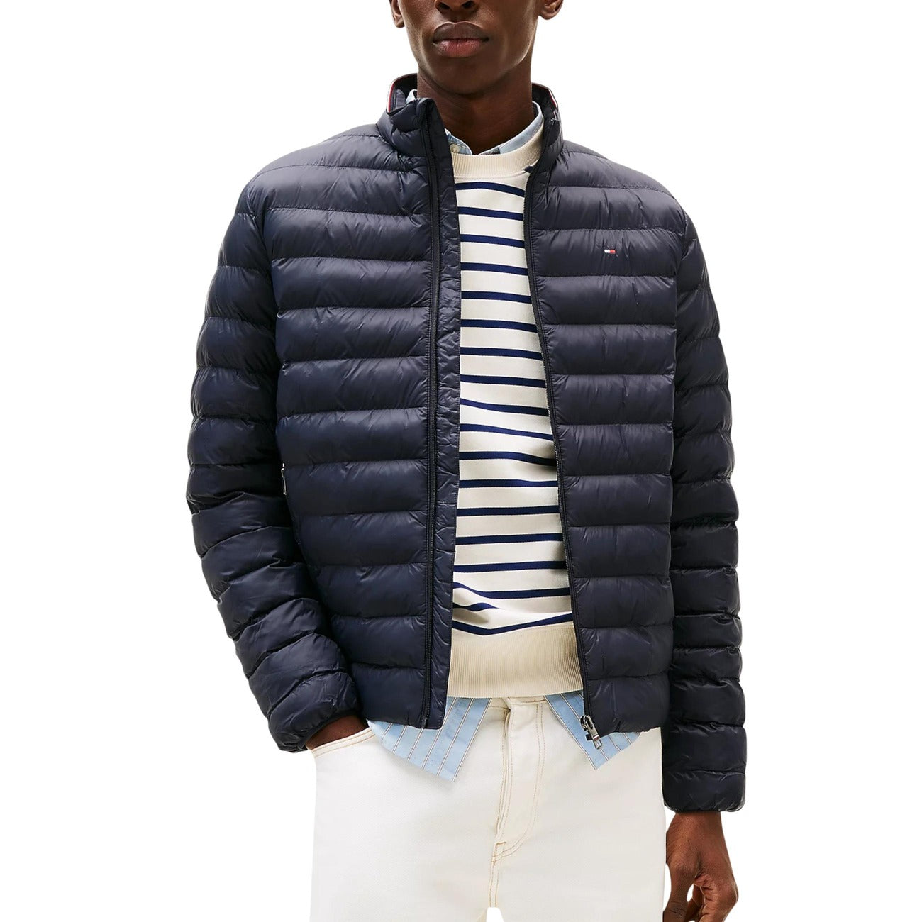 Front view of the navy puffer jacket featuring a zipper closure and quilted design against a white background.
