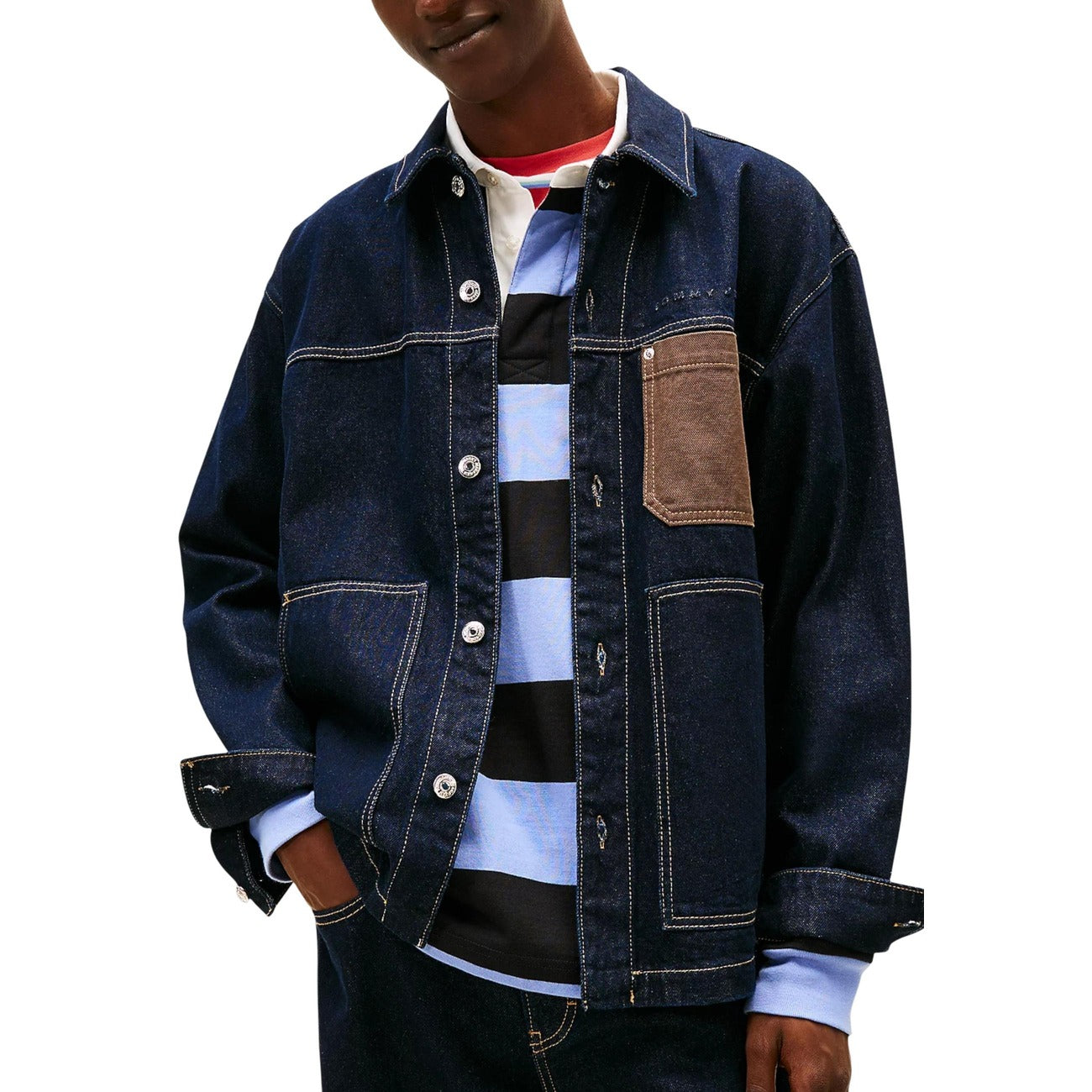 Lifestyle shot of a person wearing a blue denim jacket with a layered outfit.