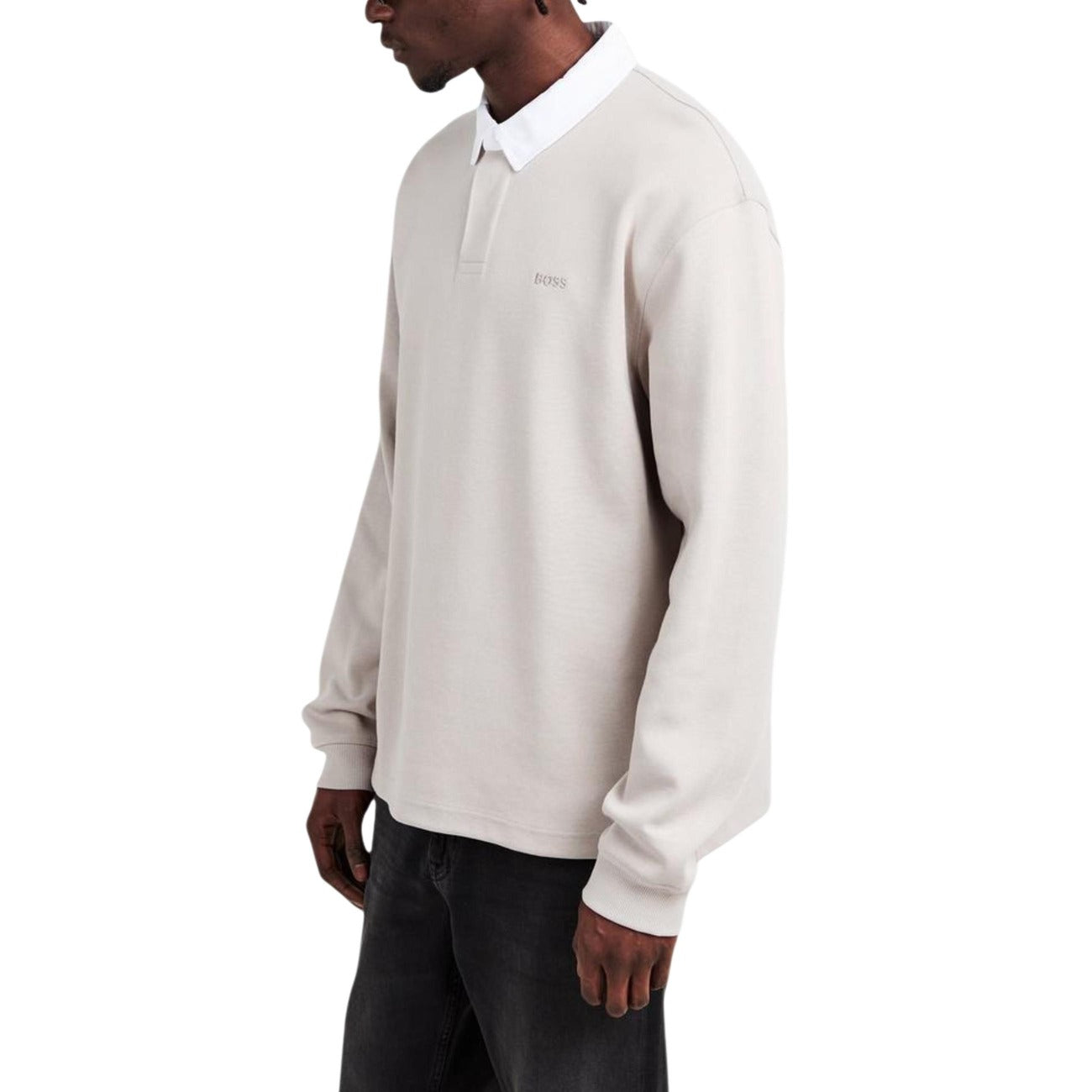 Side view of the grey long-sleeve polo shirt with a collared neckline against a white background.