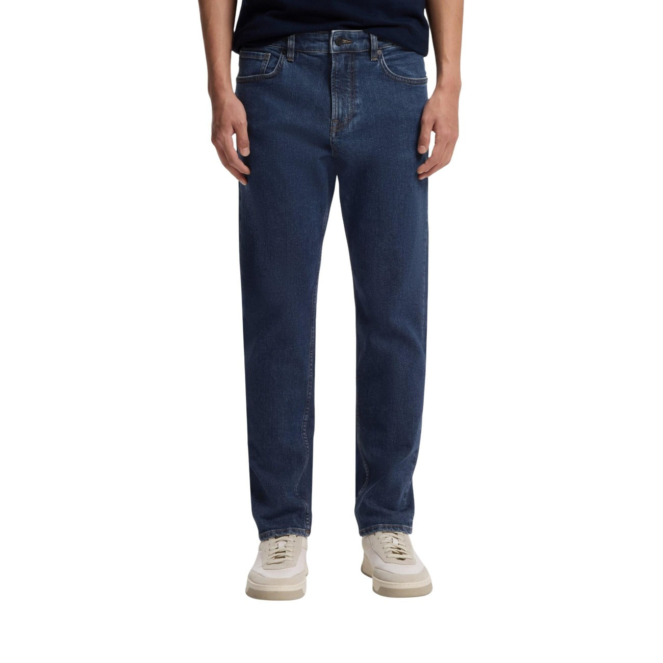 Lifestyle shot of blue jeans featuring a straight fit and five pockets on a white background.