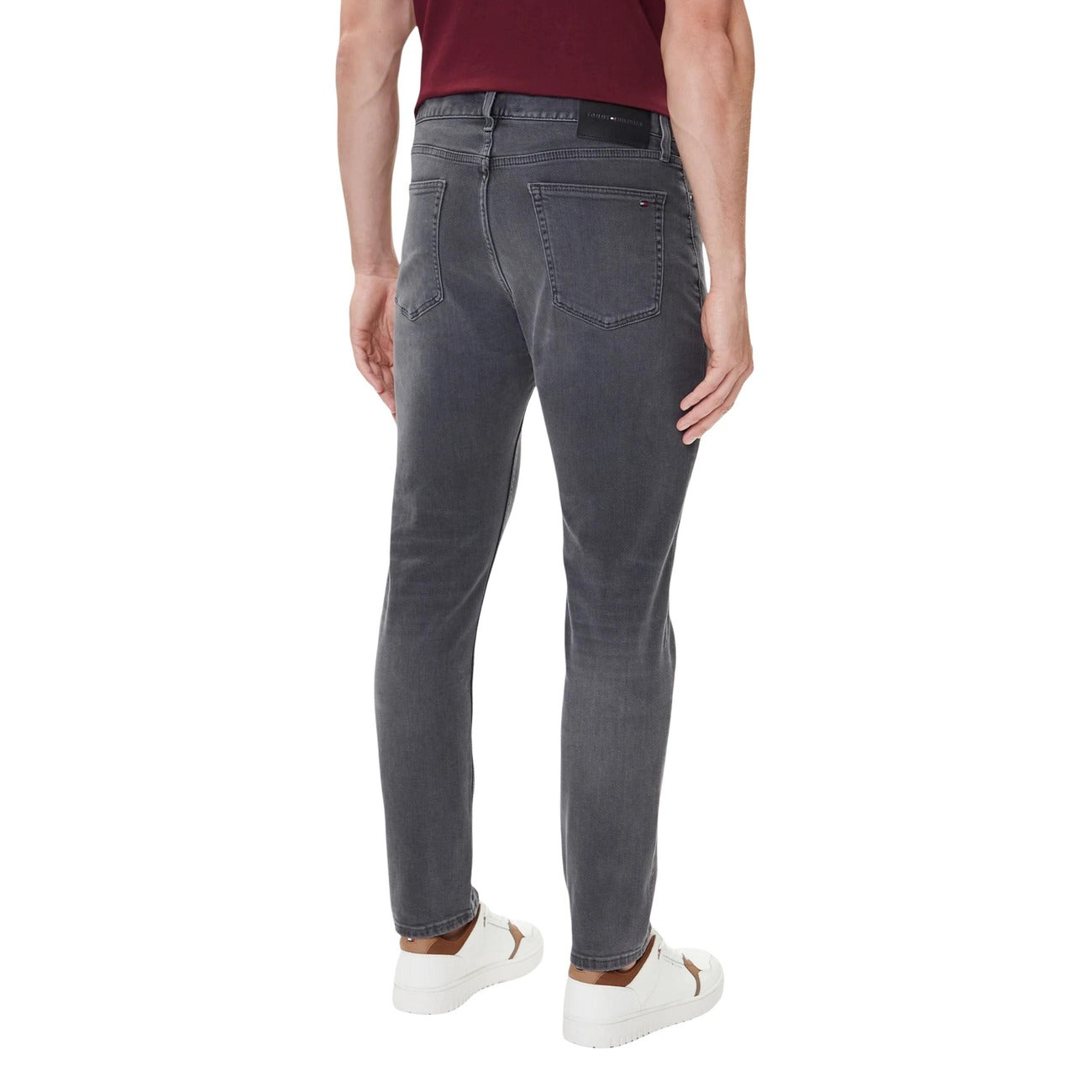 Back view of the gray slim fit jeans showcasing five pockets on a white background