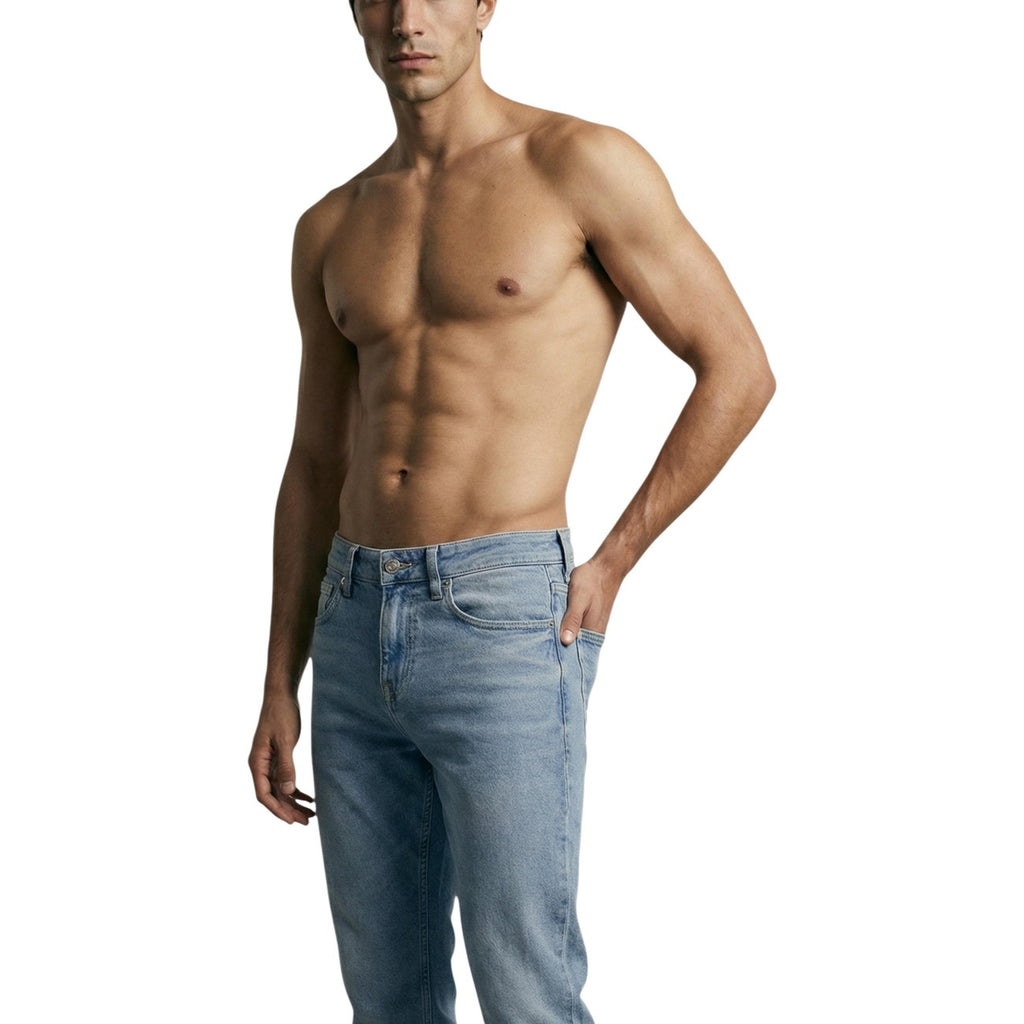 Lifestyle shot of a model wearing light blue skinny fit jeans in a casual style on a white background