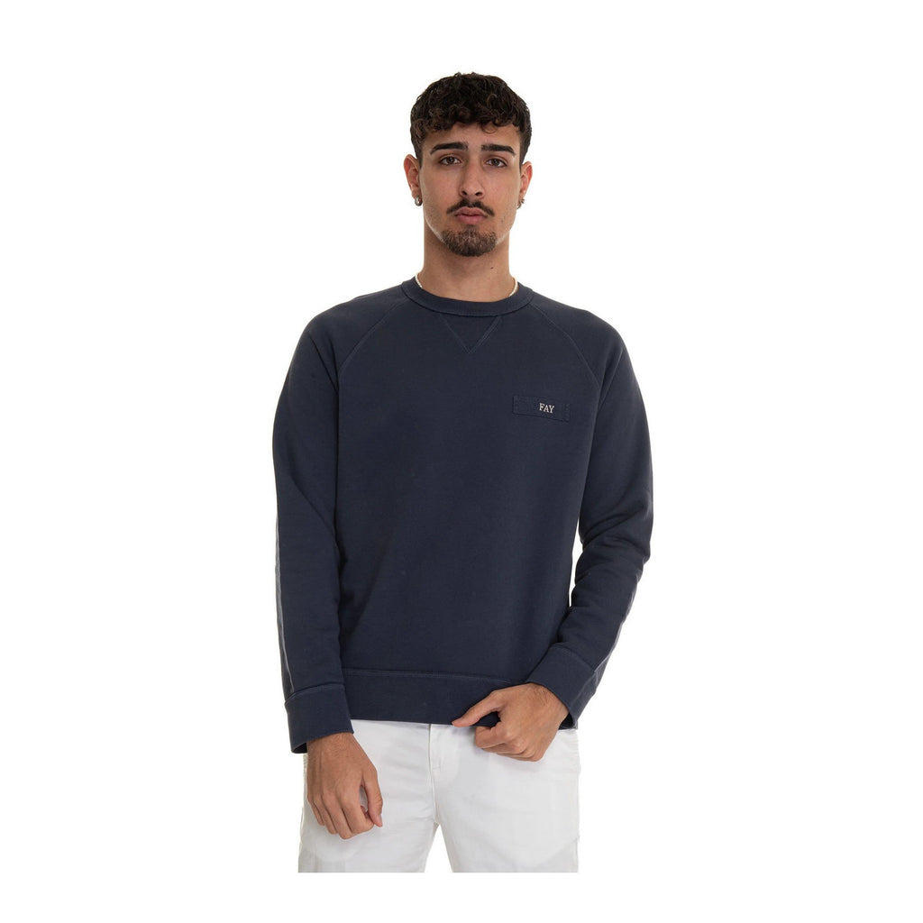 Lifestyle shot of a model showcasing the navy sweatshirt with crew neck and long sleeves
