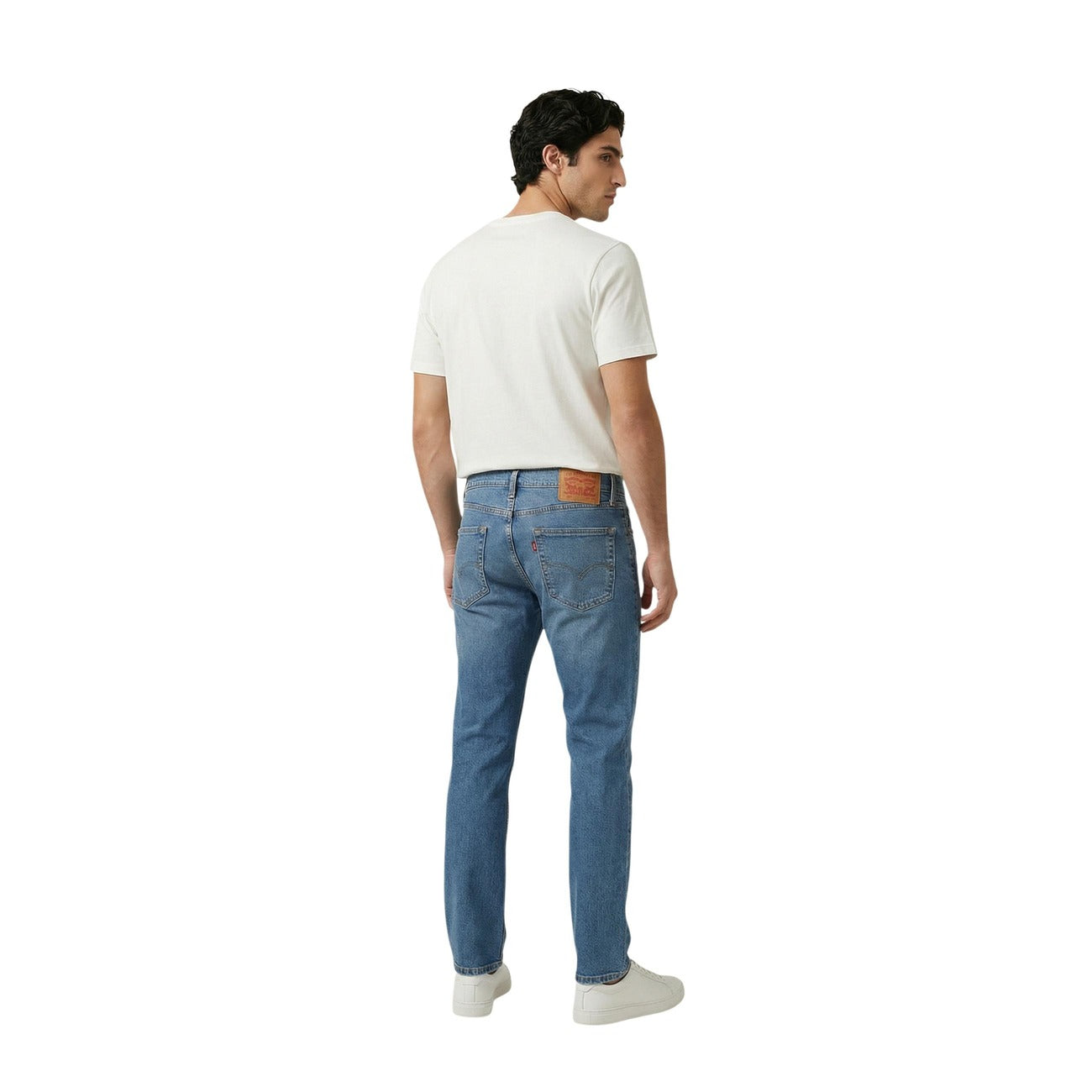 Back view of blue jeans showcasing a slim fit and five pockets against a white background