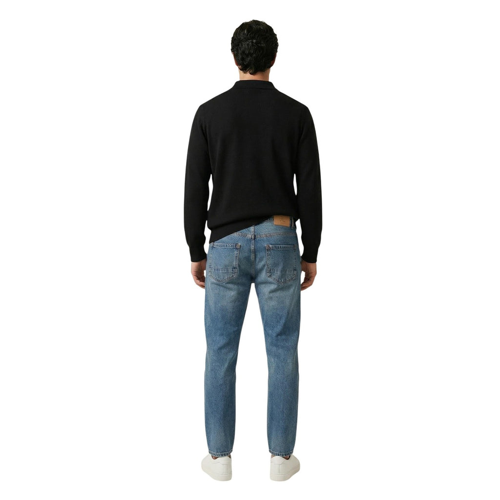 Back view of the black sweater featuring long sleeves and a classic collar on a white background