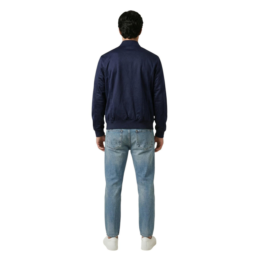 Back view of a man in a blue denim jacket showcasing a plain back on a white background.
