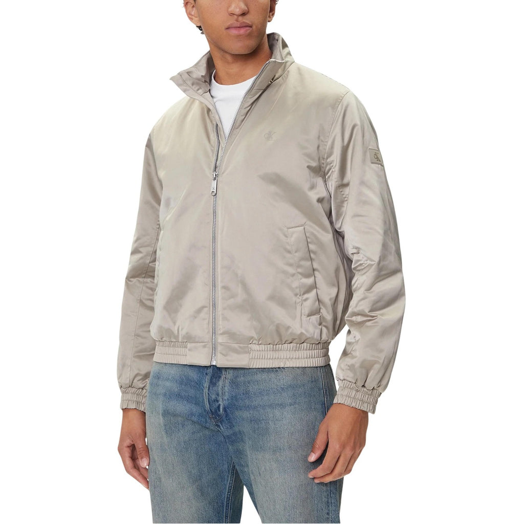 Front view of the grey blazer featuring zipper closure and front pockets.