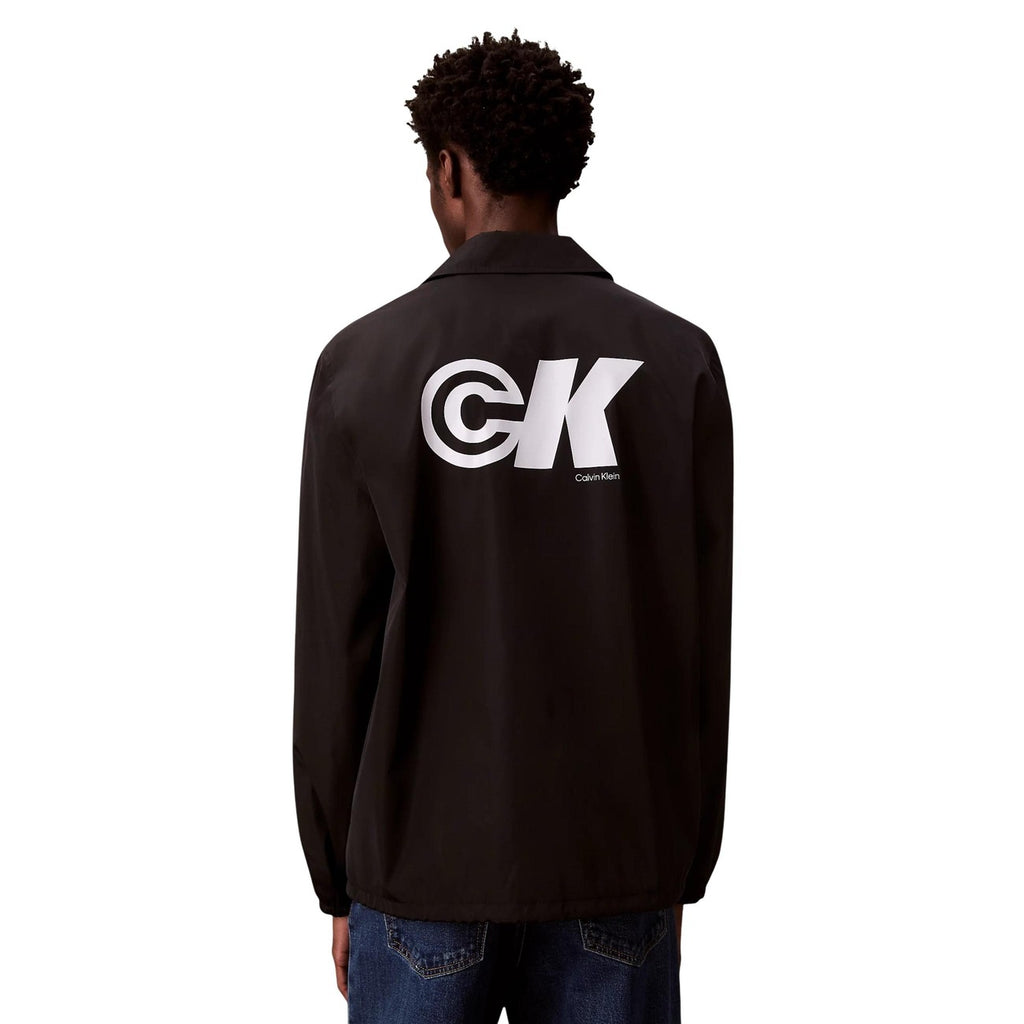 Back view of a black blazer showcasing a large logo and button closure against a white background.