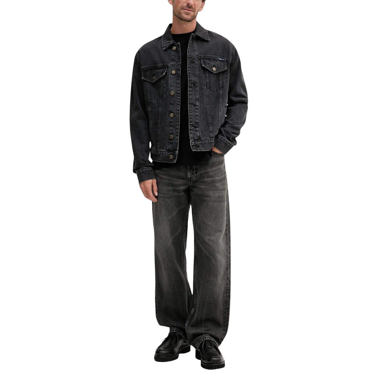 Lifestyle shot of a model wearing black jeans with a straight leg and five pockets on a white background.