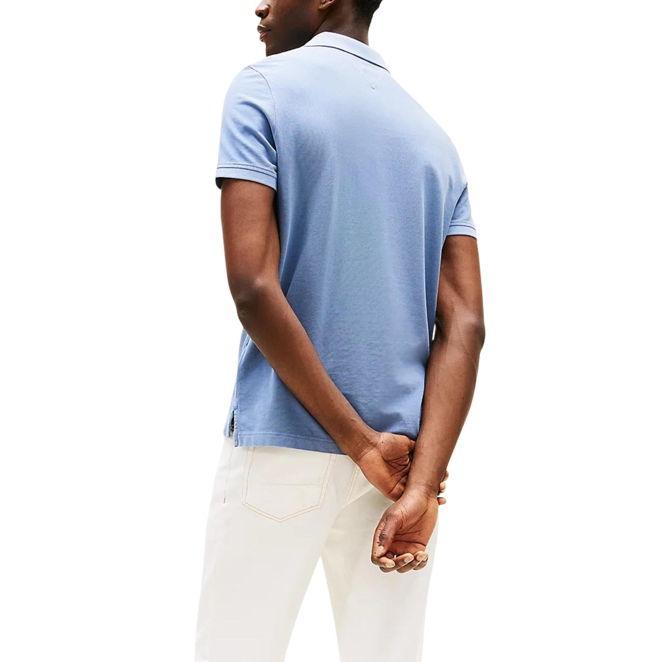 Back view of the blue polo shirt with short sleeves and a collar on a white background.