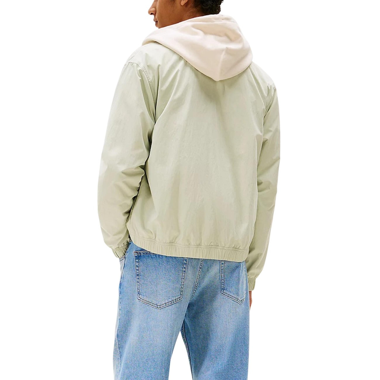 Back view of a light green casual fit jacket on a white background