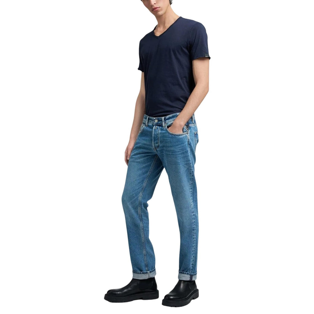 Side view of light blue slim fit jeans with rolled cuffs on a white background