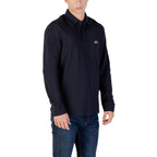 Side view of the navy long-sleeve polo shirt with collar and logo on a white background.