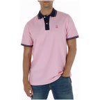 Front view of the pink polo shirt with short sleeves and logo on chest.