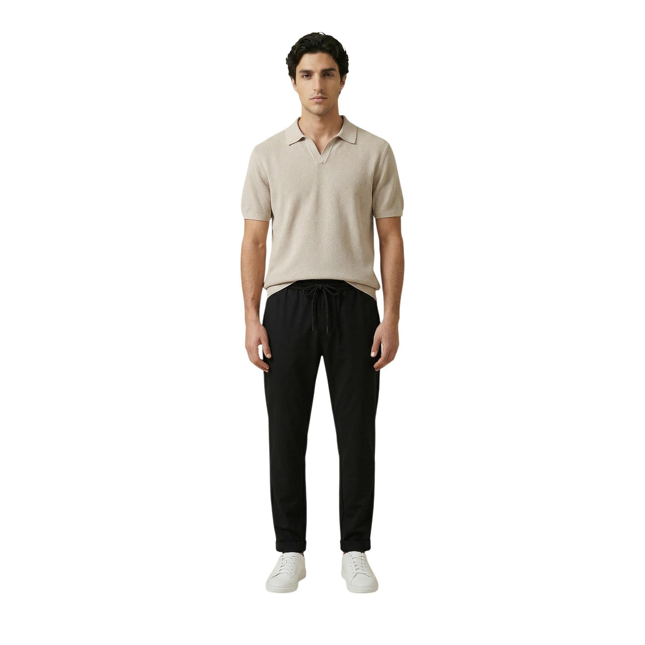 Front view of the beige polo shirt styled with black pants, showcasing short sleeves and a casual look on a white background