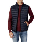 Front view of the navy puffer vest featuring zipper closure and padded design on a white background.