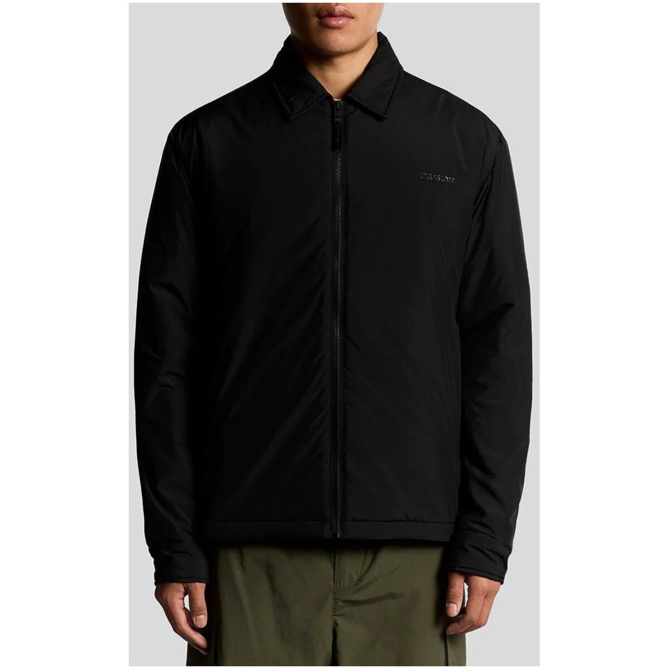 Front view of the black blazer featuring a zipper closure and collar.