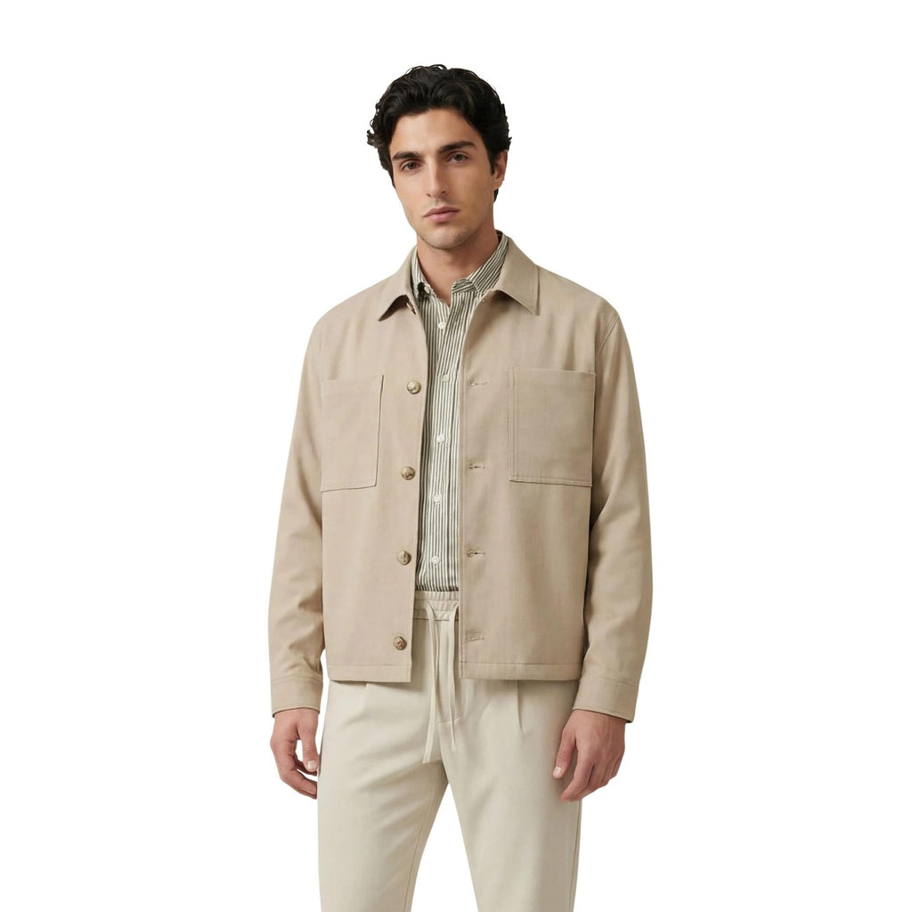 Front view of the beige blazer featuring a collar and button closure on a white background.
