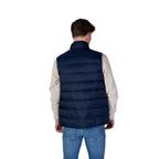 Lifestyle shot of the navy puffer vest showcasing its zipper closure and padded design.