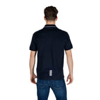 Back view of the blue polo shirt showcasing a tag at the back and short sleeves.