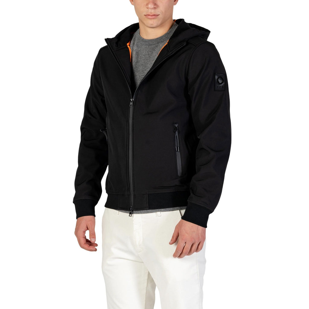 Lifestyle shot of a black hoodie blazer featuring a zipper closure and front pockets.