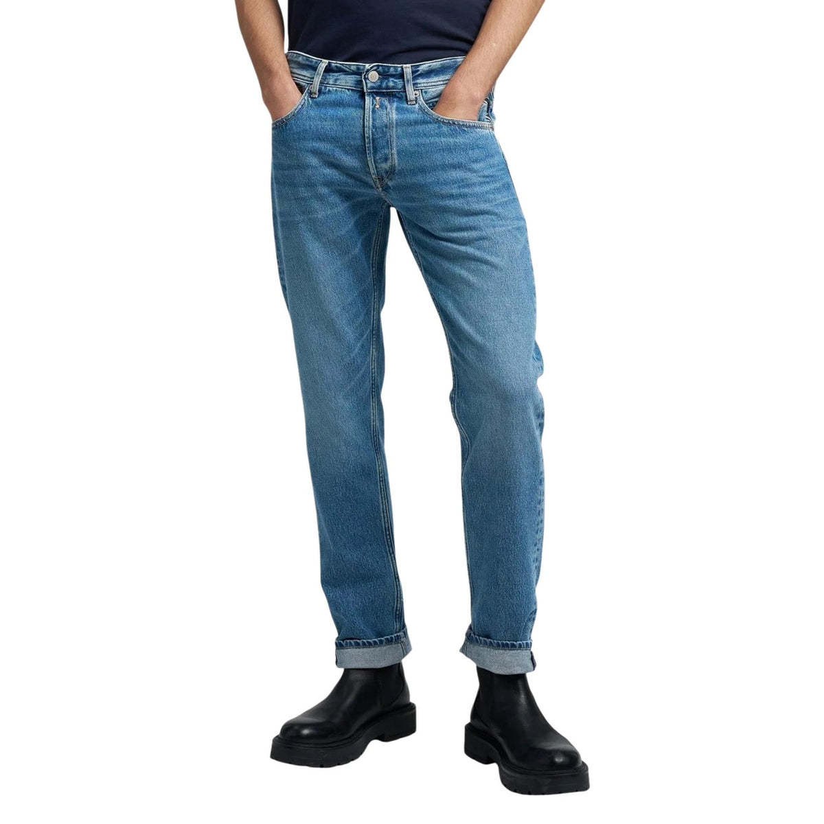 Front view of light blue slim fit jeans with rolled cuffs on a white background