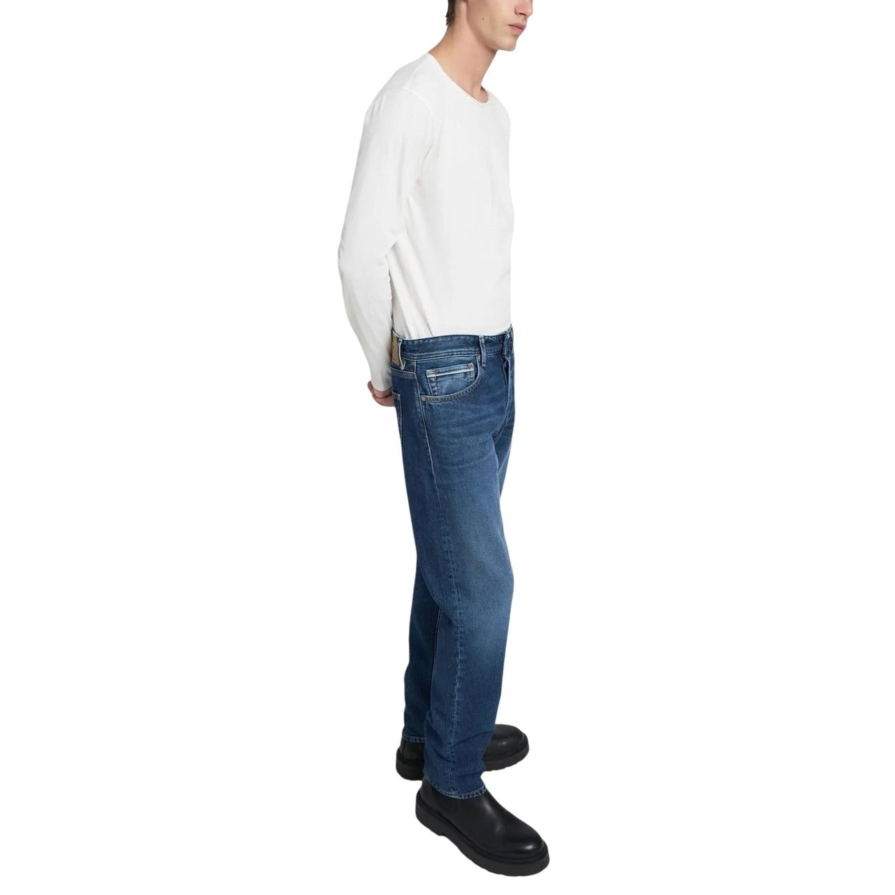 Side view of blue jeans with a slim fit and faded wash on a white background