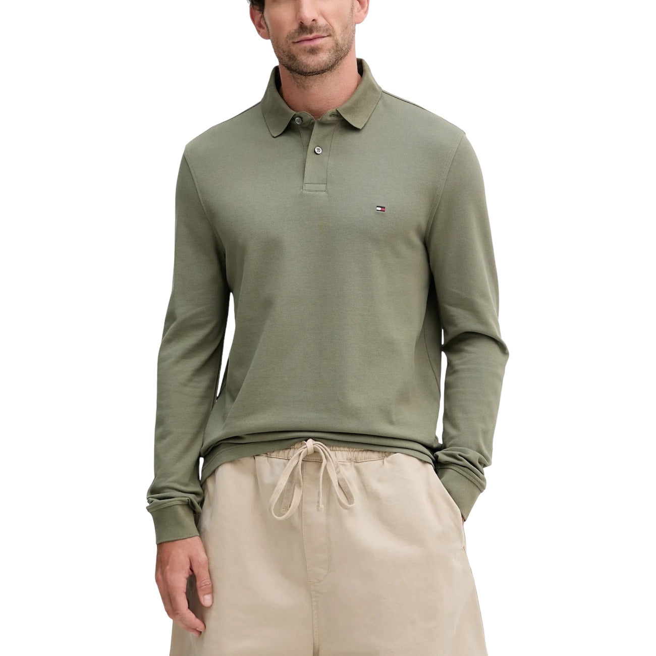 Lifestyle shot of a green long-sleeve polo with a classic collar against a white background.