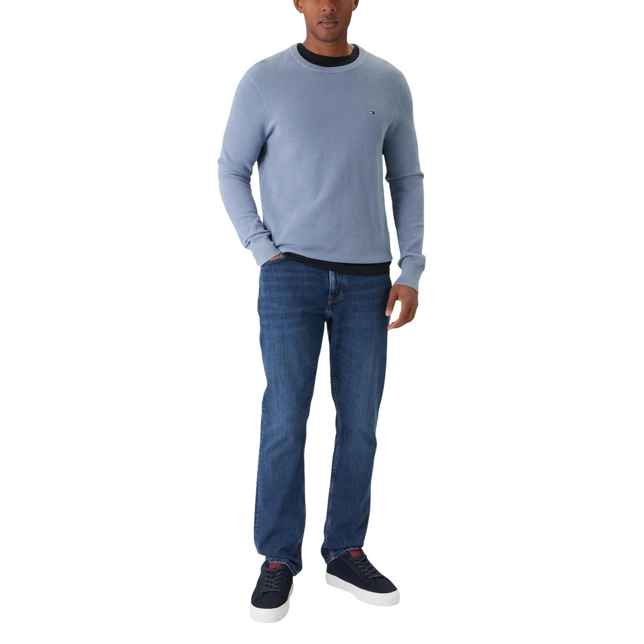 Side view of blue jeans highlighting the straight fit and five pockets.