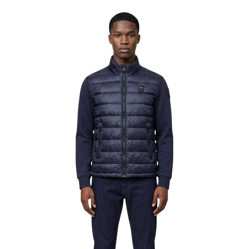 Front view of the navy puffer jacket featuring a zipper closure and quilted design.