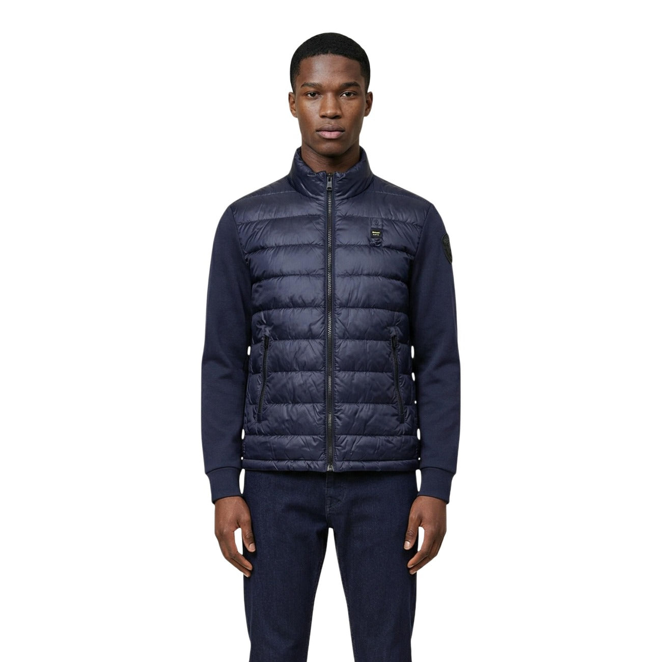 Front view of the navy puffer jacket featuring a zipper closure and quilted design.