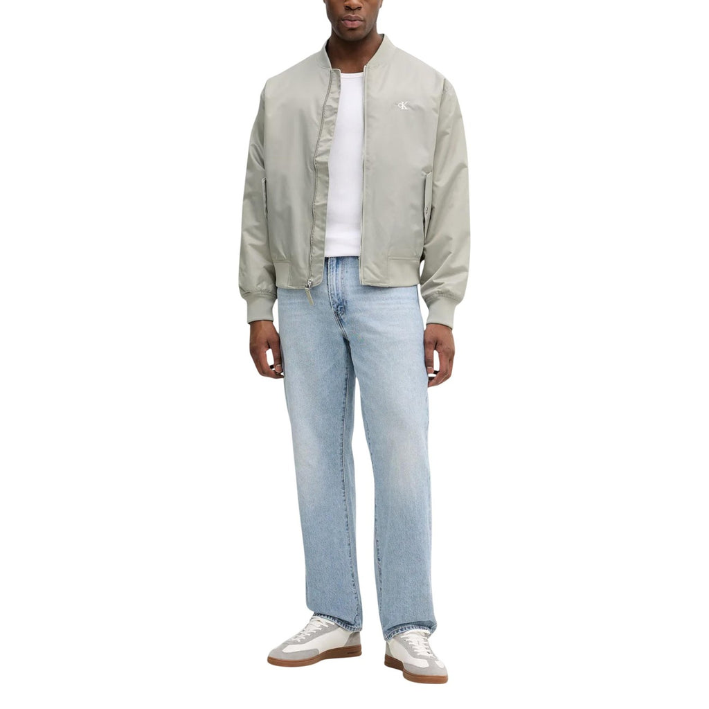Lifestyle shot of the green blazer featuring a casual fit against a white background