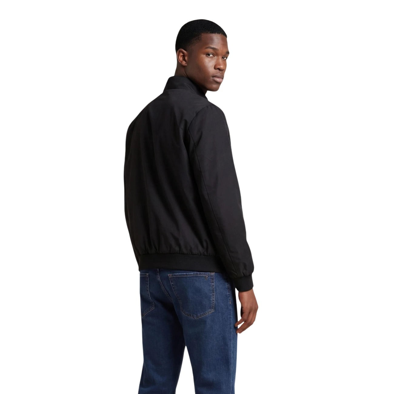Lifestyle shot of the black Ea7 blazer paired with jeans, showcasing zipper closure and logo.