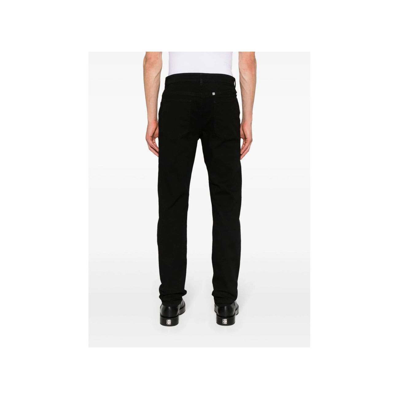 Back view of black Givenchy men's jeans with flared legs and pockets on a white background.