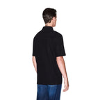 Back view of the black polo shirt showcasing short sleeves and a collar on a white background.